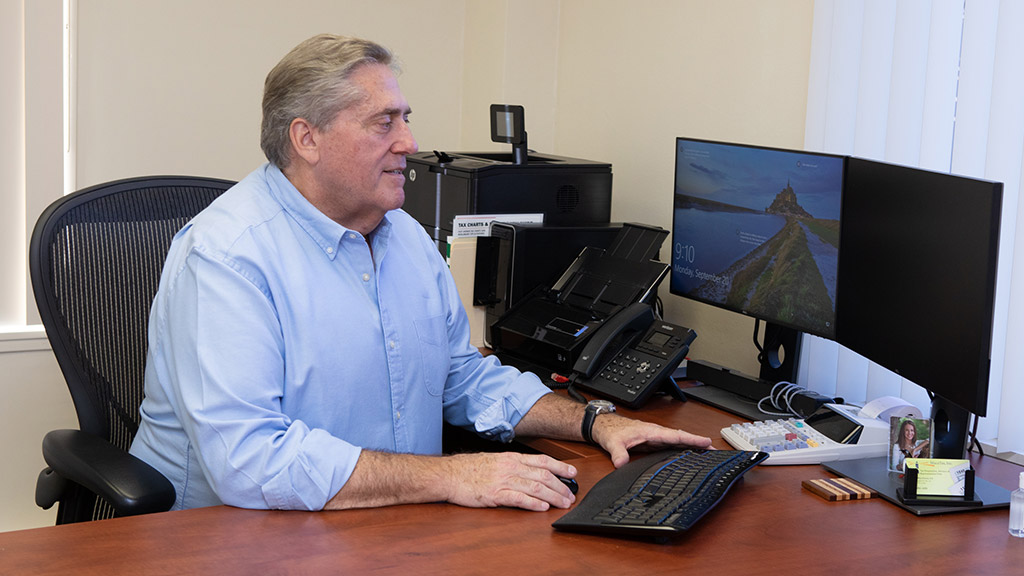 MacaTax founder Richard MacAlesse working at his desk.